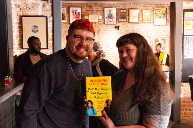 Dominic Green (left) and Molly Welsh (right) hold up a copy of book 